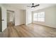 Bright bedroom with wood-look floors, ceiling fan, and ample closet space at 2328 Sanders Ave, Charlotte, NC 28216