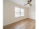 Simple bedroom with hardwood floors and a large window at 2328 Sanders Ave, Charlotte, NC 28216