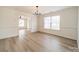 Light-filled dining area with hardwood floors and access to living space at 2328 Sanders Ave, Charlotte, NC 28216