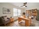 Home office with built-in shelving, hardwood floors, and a workspace at 2328 Sanders Ave, Charlotte, NC 28216