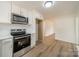 Modern kitchen with white cabinets and stainless steel appliances at 2328 Sanders Ave, Charlotte, NC 28216