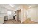 Modern kitchen with white cabinets, stainless steel appliances, and vinyl flooring at 2328 Sanders Ave, Charlotte, NC 28216