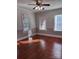 Hardwood floor bedroom with multiple windows and window blinds at 300 S Thompson St, Shelby, NC 28150