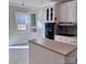 Kitchen with white cabinets and a corner pantry at 300 S Thompson St, Shelby, NC 28150