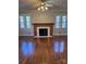 Living room featuring hardwood floors and a wood-burning fireplace at 300 S Thompson St, Shelby, NC 28150