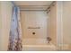 Clean bathroom featuring a shower/tub combo and floral shower curtain at 304 Edel St, Kings Mountain, NC 28086