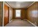 Simple bedroom with wood paneling walls and neutral carpeting at 304 Edel St, Kings Mountain, NC 28086