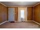 Living room with wood paneling, carpet, and a window at 304 Edel St, Kings Mountain, NC 28086