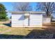 White shed with a door and small awning in backyard at 304 Edel St, Kings Mountain, NC 28086