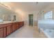 Elegant bathroom with double vanity and soaking tub at 4225 Nathaniel Glen Ct, Matthews, NC 28105