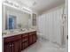 Clean bathroom with double vanity and shower/tub at 4225 Nathaniel Glen Ct, Matthews, NC 28105