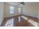 Well-lit bedroom with hardwood floors and ceiling fan at 4225 Nathaniel Glen Ct, Matthews, NC 28105