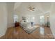 Bright bedroom featuring hardwood floors and a ceiling fan at 4225 Nathaniel Glen Ct, Matthews, NC 28105