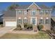 Brick two-story house with green shutters, landscaping, and a two-car garage at 4225 Nathaniel Glen Ct, Matthews, NC 28105