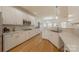 Eat-in kitchen with white cabinetry, stainless steel appliances and hardwood floors at 4225 Nathaniel Glen Ct, Matthews, NC 28105