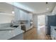 Modern kitchen featuring stainless steel appliances, white cabinetry, and hardwood floors at 4225 Nathaniel Glen Ct, Matthews, NC 28105