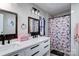 Modern bathroom with double vanity and floral shower curtain at 427 Twin Oaks Rd, Statesville, NC 28625