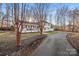 White two-story house with a spacious front porch and long driveway at 4501 Brookwood Rd, Charlotte, NC 28215