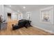 Living room with hardwood floors, sectional sofa, and exercise bike at 4501 Brookwood Rd, Charlotte, NC 28215