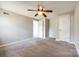 Comfortable carpeted bedroom with a ceiling fan and ensuite bathroom access at 4901 Smokehollow Rd, Charlotte, NC 28227