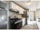 Well-lit kitchen with stainless steel appliances and white cabinets at 4901 Smokehollow Rd, Charlotte, NC 28227