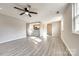 Spacious living room features hardwood floors, a ceiling fan, and natural light at 4901 Smokehollow Rd, Charlotte, NC 28227