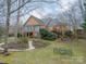 Landscaped backyard with brick home and deck at 5218 Shadow Pond Ln, Charlotte, NC 28226