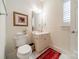 Updated bathroom with single vanity, toilet and tile floors at 5218 Shadow Pond Ln, Charlotte, NC 28226