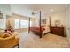 Spacious bedroom with a large window and comfortable seating at 5218 Shadow Pond Ln, Charlotte, NC 28226