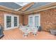 Brick patio with a wooden deck and outdoor furniture at 5218 Shadow Pond Ln, Charlotte, NC 28226