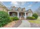 Stone house with a large front porch and landscaped yard at 5218 Shadow Pond Ln, Charlotte, NC 28226