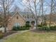 Stone house with a large front porch and landscaped yard at 5218 Shadow Pond Ln, Charlotte, NC 28226