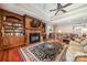 Gathering room features built-in shelving, fireplace and hardwood floors at 5218 Shadow Pond Ln, Charlotte, NC 28226