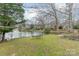 Peaceful backyard setting overlooking a serene lake at 5218 Shadow Pond Ln, Charlotte, NC 28226