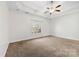 Bright bedroom featuring a ceiling fan and large window at 5428 Old Course Dr, Cramerton, NC 28032