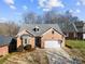 Brick ranch home with attached garage and landscaped yard at 5428 Old Course Dr, Cramerton, NC 28032