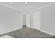 Spacious bedroom with gray walls, gray flooring, and double doors at 624 Gaywood Dr, Charlotte, NC 28273