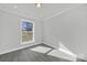 Bright bedroom with a large window, gray walls, and gray flooring at 624 Gaywood Dr, Charlotte, NC 28273