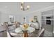 Modern dining area with glass table and kitchen view at 624 Gaywood Dr, Charlotte, NC 28273