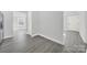 Clean hallway with light gray walls and gray laminate flooring at 624 Gaywood Dr, Charlotte, NC 28273