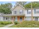 Tan and brick townhouse with blue shutters and a walkway at 6325 Windsor Gate Ln, Charlotte, NC 28215