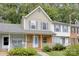 Brick front townhouse with a charming porch and well-maintained landscaping at 6325 Windsor Gate Ln, Charlotte, NC 28215