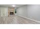 Living room with stone fireplace and wood-look flooring at 6325 Windsor Gate Ln, Charlotte, NC 28215