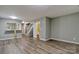 Open living area with wood-look floors and a view into the kitchen at 6325 Windsor Gate Ln, Charlotte, NC 28215