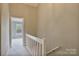 Upstairs hallway with carpet and access to bedrooms at 6325 Windsor Gate Ln, Charlotte, NC 28215