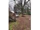 Spacious backyard with mature trees and car at 7119 Neal Rd, Charlotte, NC 28262