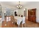 Bright dining room with hardwood floors, chandelier, and built-in hutch at 8839 Blooming Arbor St, Huntersville, NC 28078