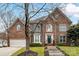 Brick two-story house with a large front yard and attached garage at 8839 Blooming Arbor St, Huntersville, NC 28078