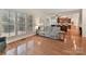 Gathering room with hardwood floors and view into the kitchen at 8839 Blooming Arbor St, Huntersville, NC 28078