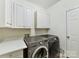 Laundry room with washer, dryer, and ample cabinets at 8839 Blooming Arbor St, Huntersville, NC 28078